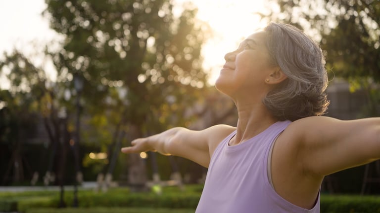 Asia adult aged people middle age mindful happy old woman open arm yoga deep calm stress relief outdoor nature public park sun light self love relax elder aging life asian female mental health care.