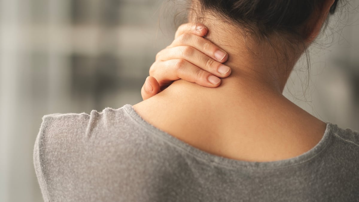 Woman suffering from nape pain in her neck